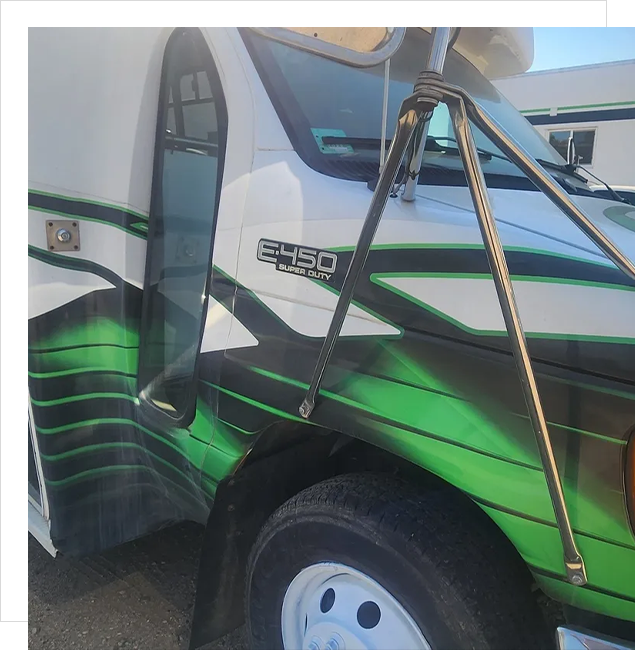 A close up of the side of a truck with green and white stripes.