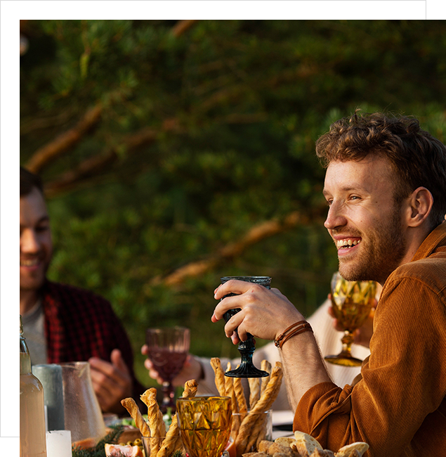 A group of people sitting at a table with food.