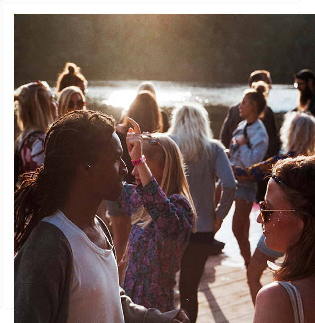 A group of people standing around in the sun.